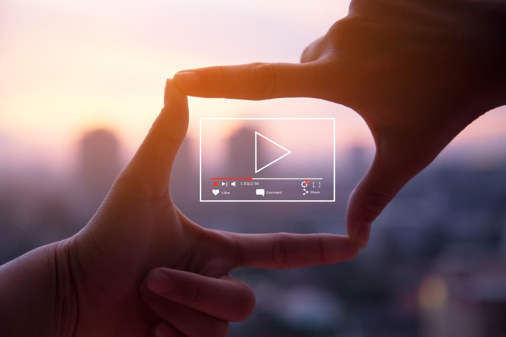 person-holding-a-video-ui Videographer holding a video logo